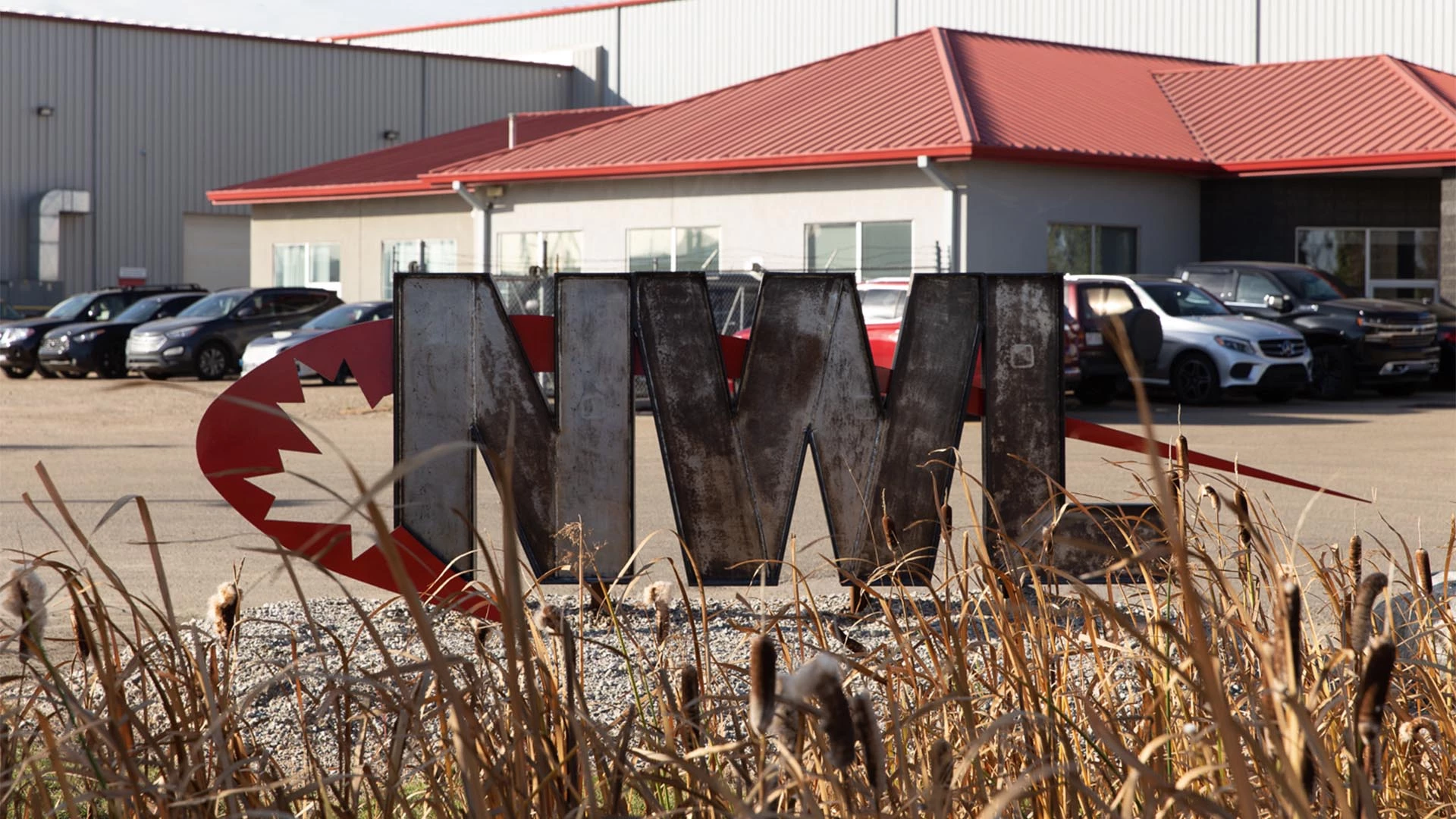 A welded NWL sign in front of Northern Welder's shop